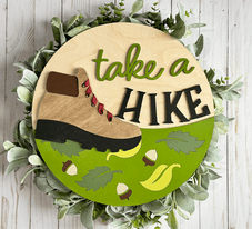 Painted version of wooden sign kit saying take a hike.