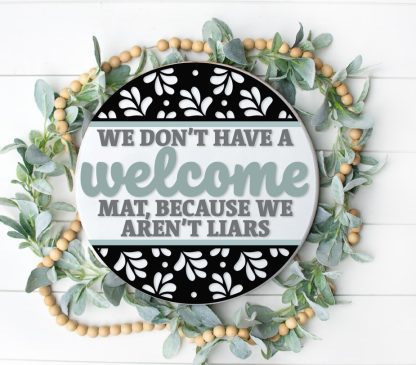 Painted version of wooden sign kit saying We don't have a welcome mat because we aren't liars.